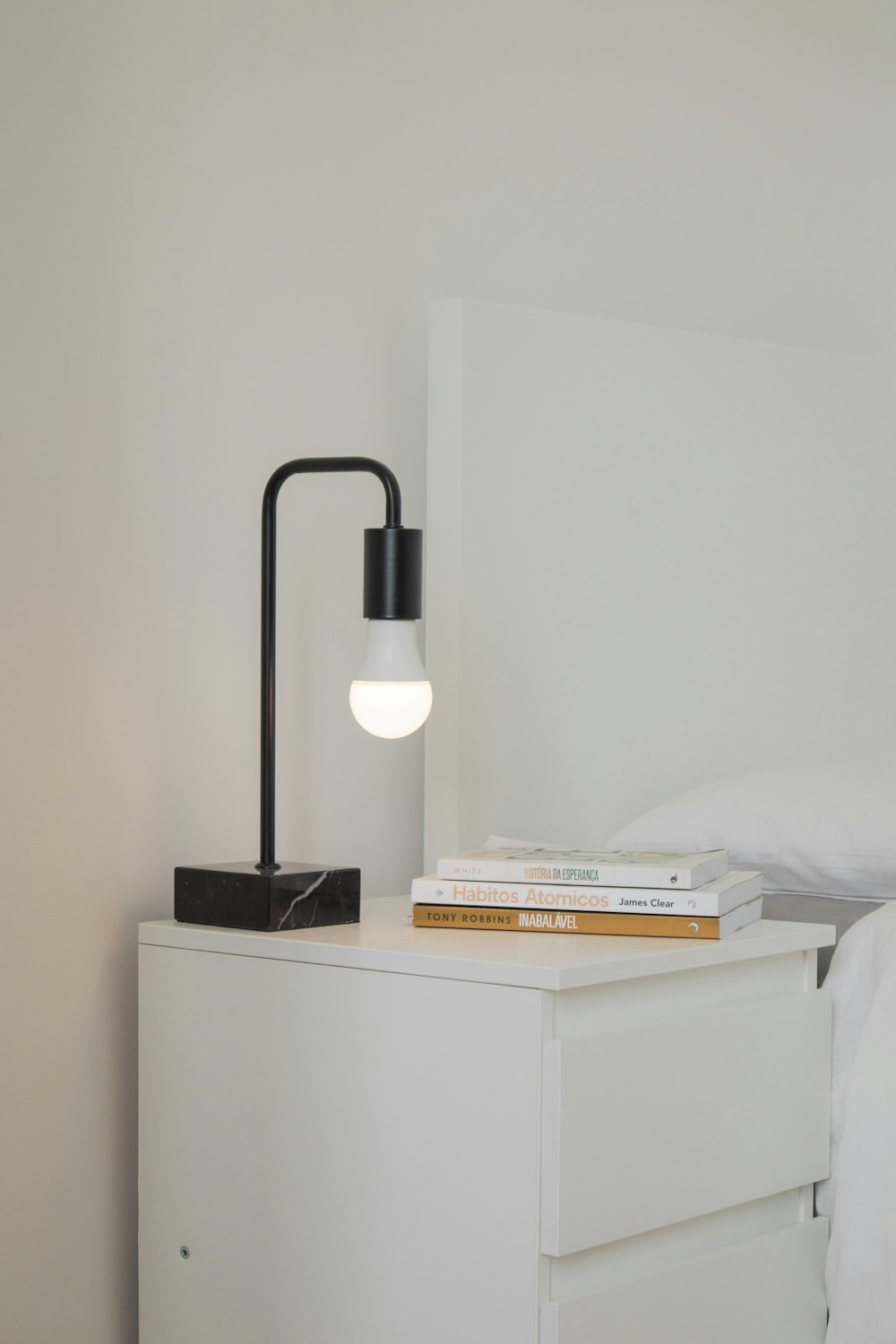 white and black desk lamp on white wooden table