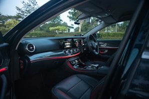 The interior of a taxi showing comfortable seats and a neat dashboard.