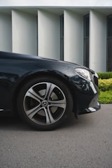 A sleek luxury car parked in an upscale urban environment, showcasing elegance and sophistication.