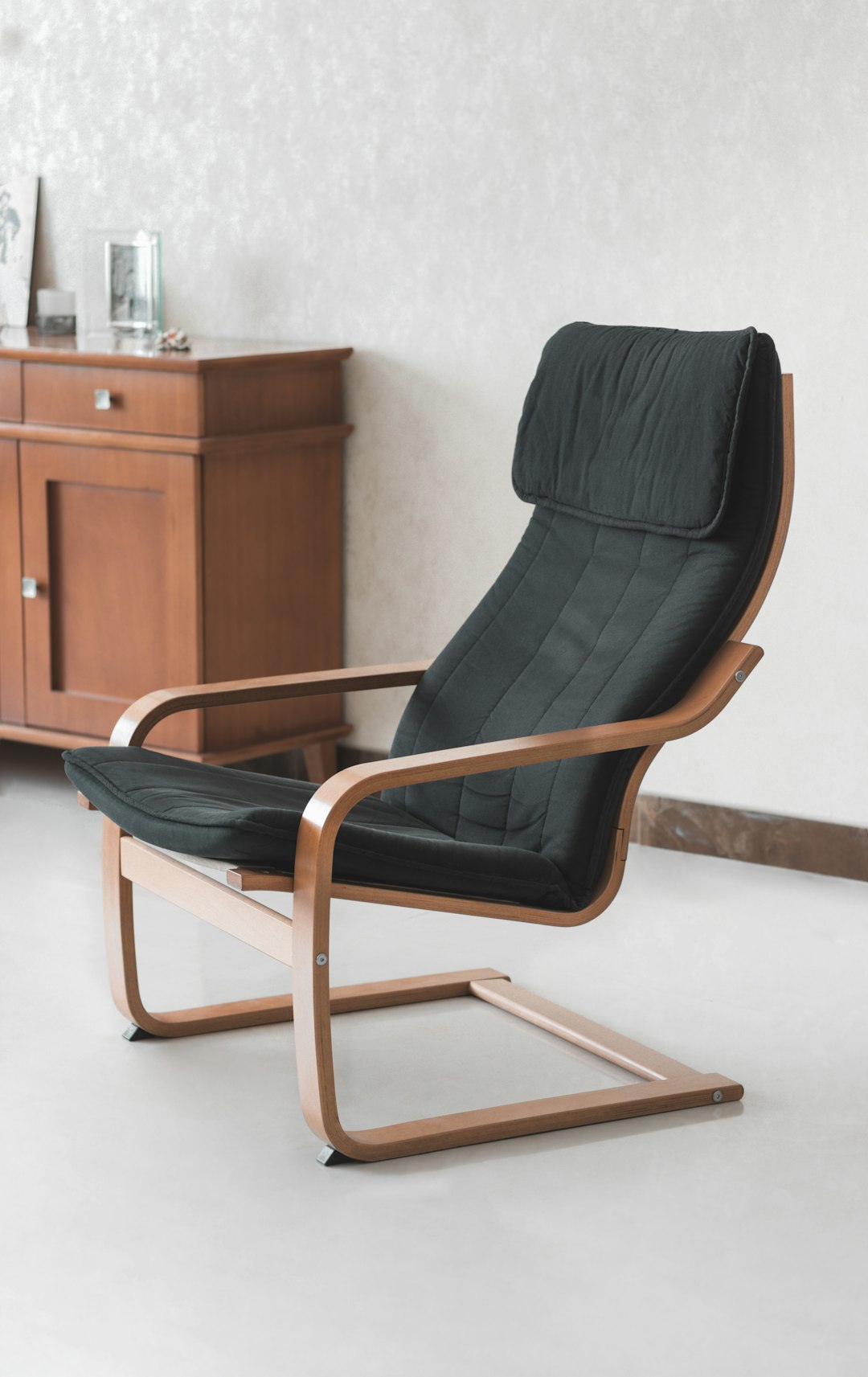  black padded brown wooden armchair chair