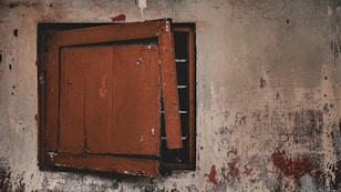 Damaged window frame with visible lead-based paint chipping