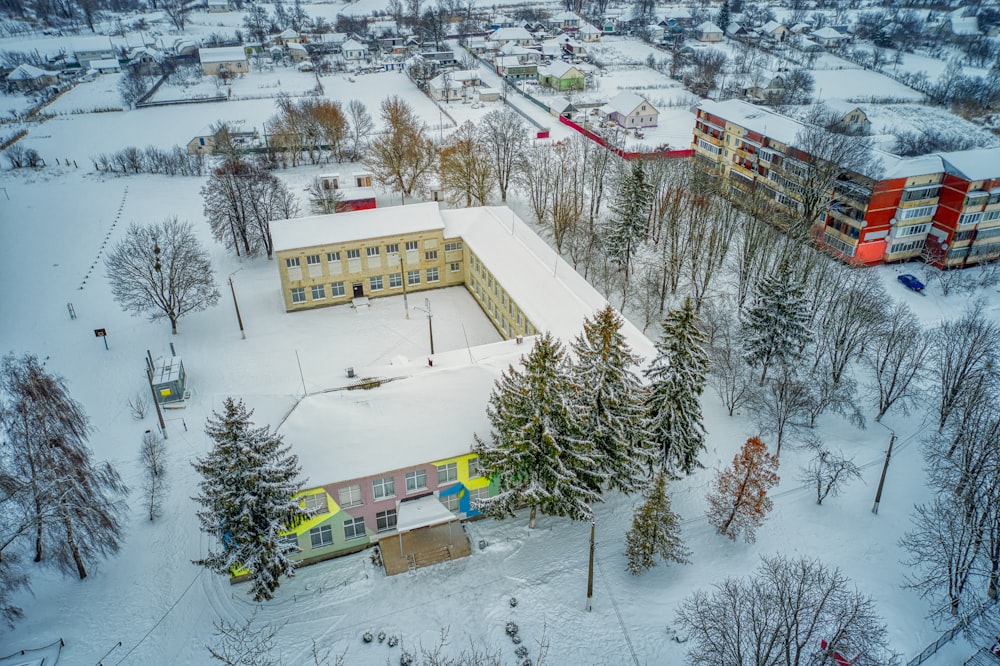 white and brown concrete building on snow covered ground