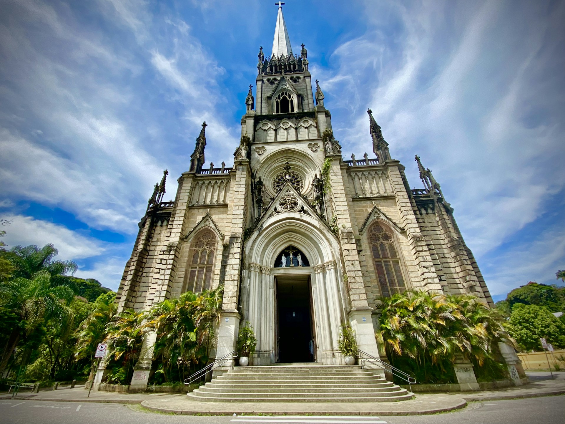 white and brown concrete church under white clouds and blue sky during daytime