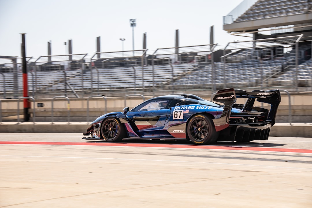 blue and red racing car on track during daytime