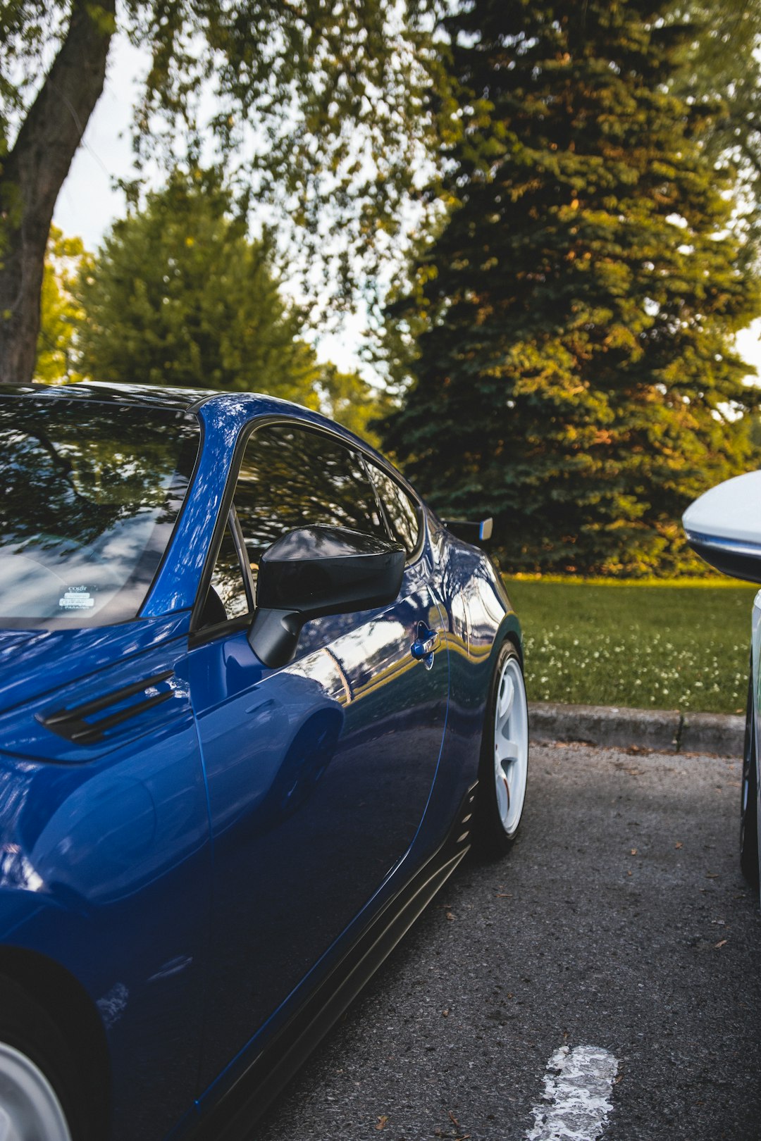 blue car parked on the side of the road