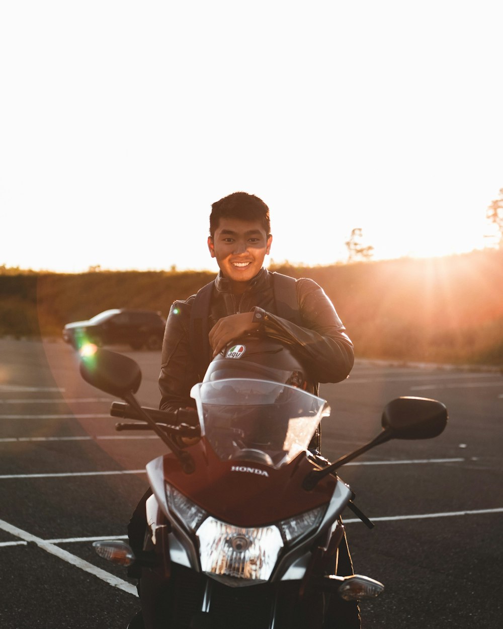 man in black jacket sitting on black and white stroller during sunset