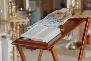 An open book of Masonic rituals resting on a lectern.