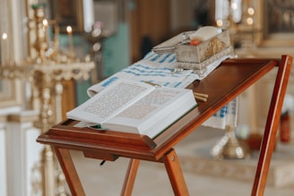 An open book of Masonic rituals resting on a lectern.
