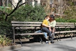 Couple enjoying a candid moment in a scenic park setting.
