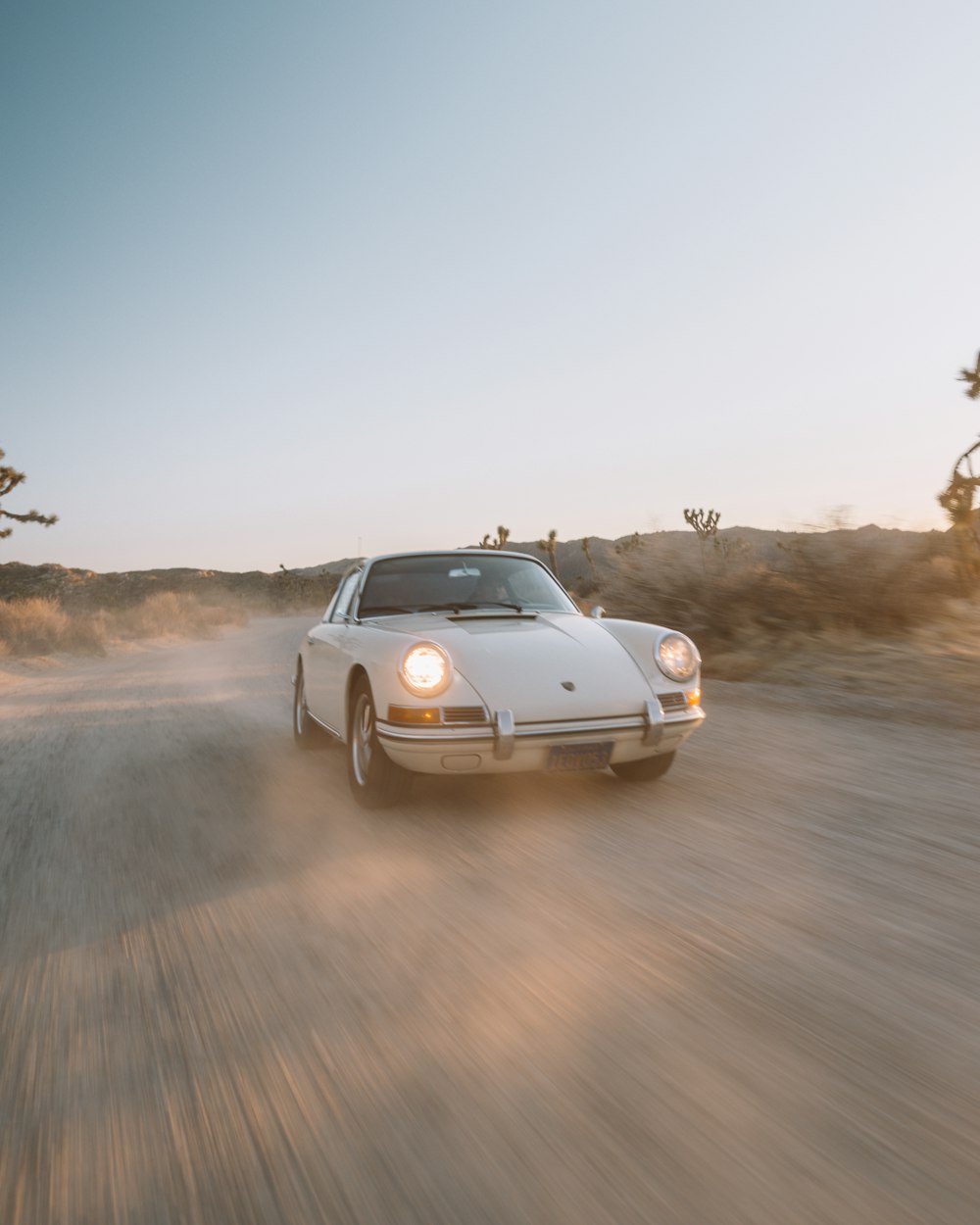 white convertible car on brown field during daytime