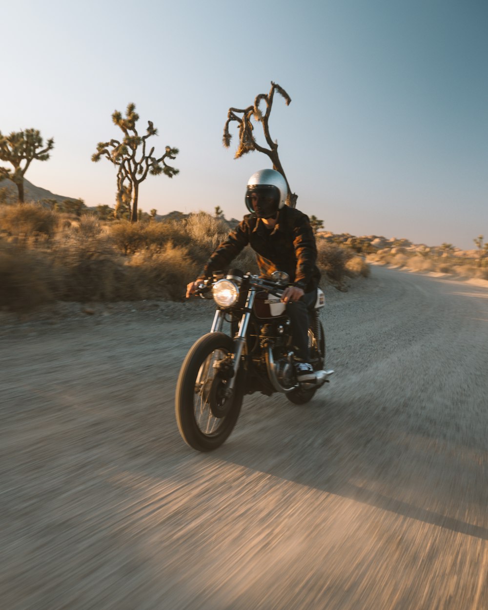 man in black motorcycle helmet riding motorcycle on road during daytime