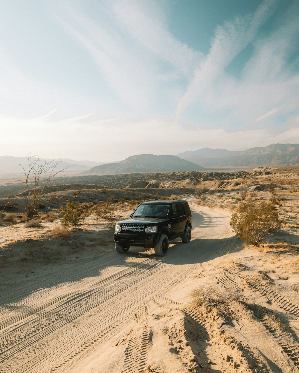 black suv on brown sand during daytime