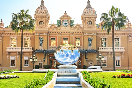 brown concrete building with round glass globe on top during daytime