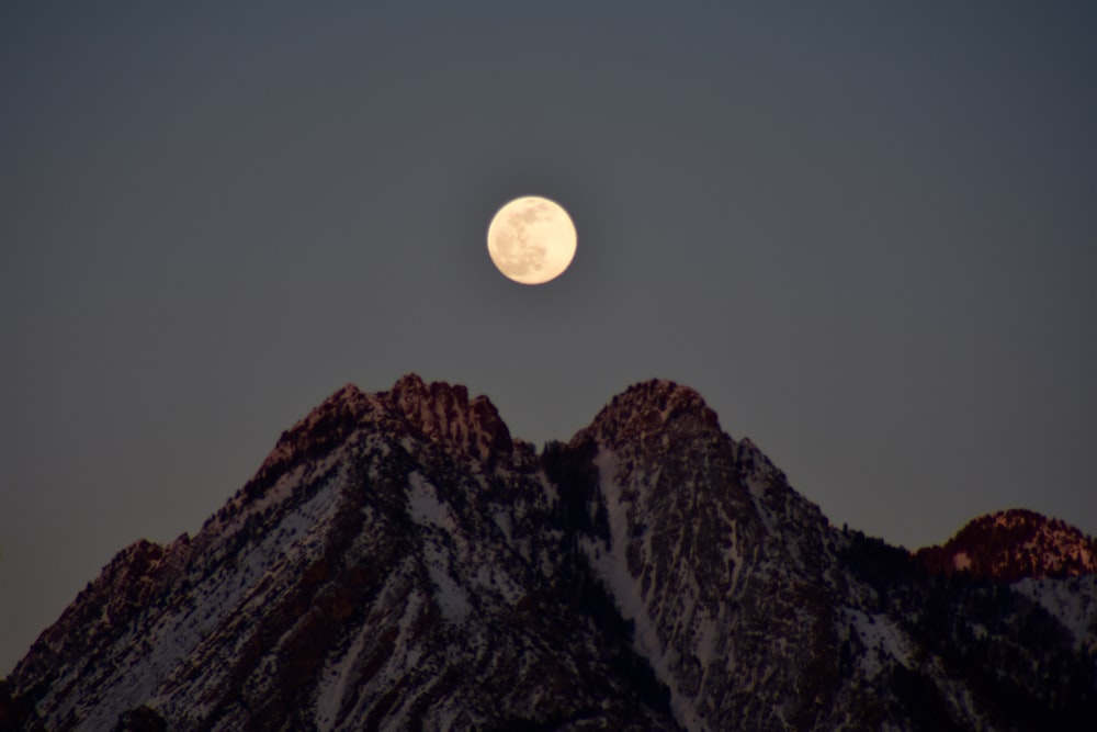 full moon over brown mountain