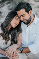 man in white dress shirt hugging woman in white dress shirt