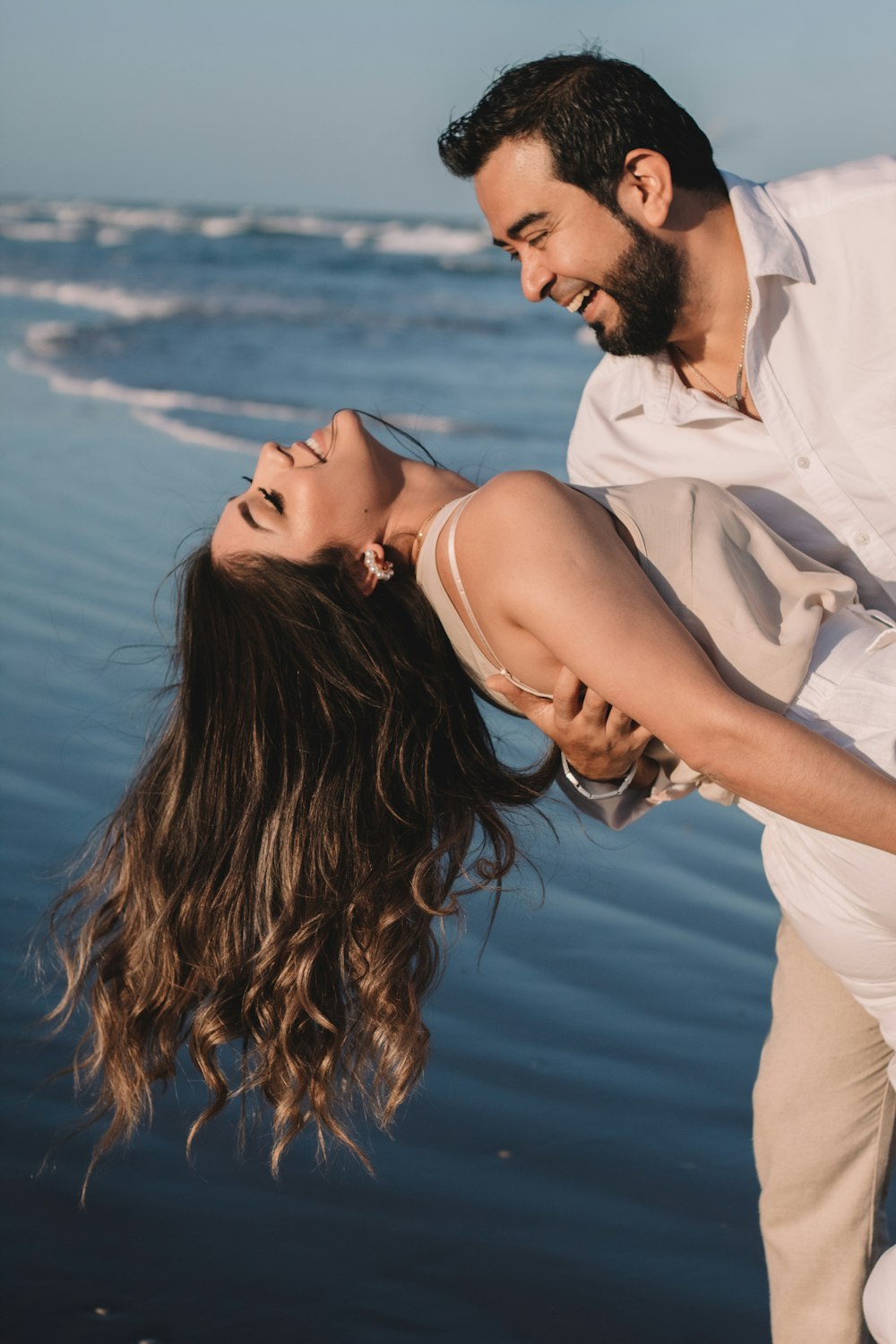 man in white dress shirt kissing woman in white dress