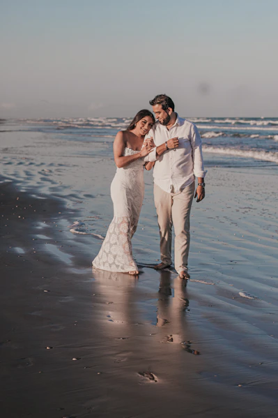 man and woman kissing on beach during daytime