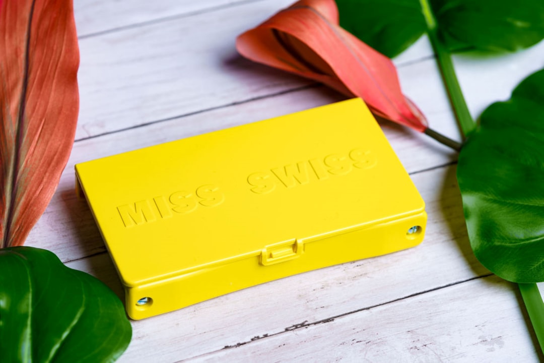 yellow plastic case on white wooden table