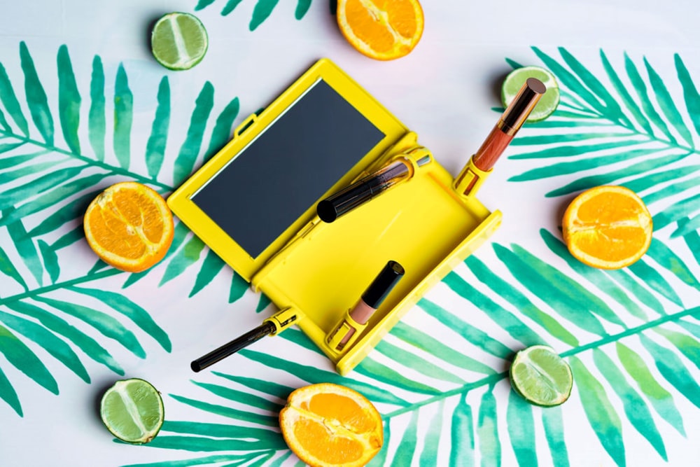 yellow and black tablet computer on white table