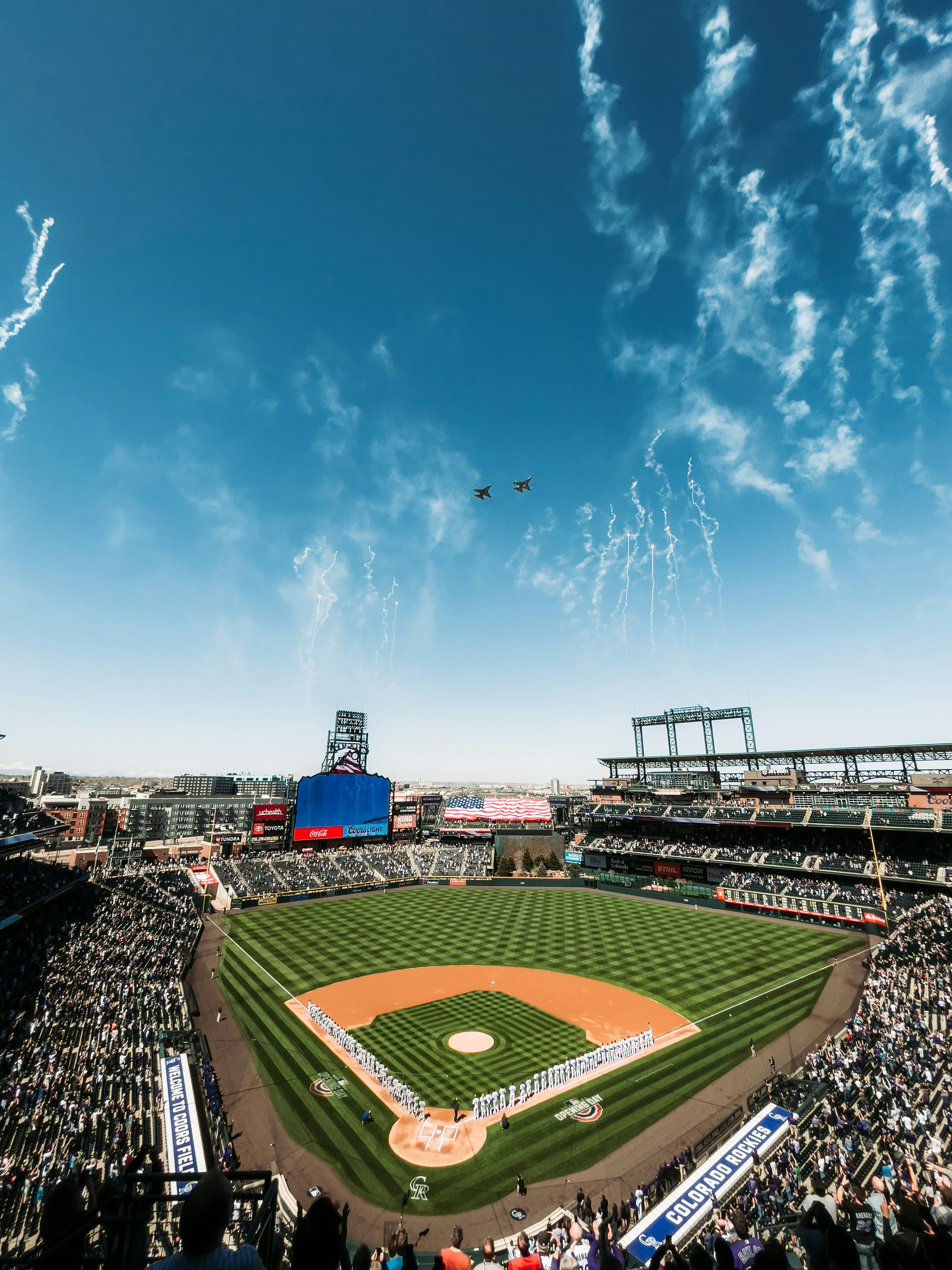 people on stadium under blue sky during daytime