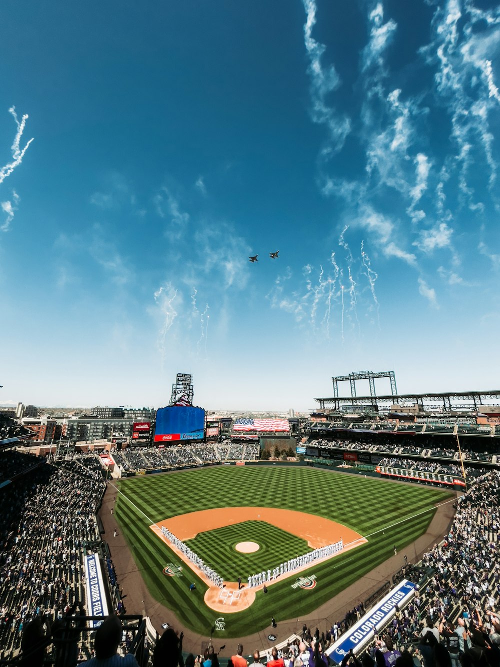 people on stadium under blue sky during daytime