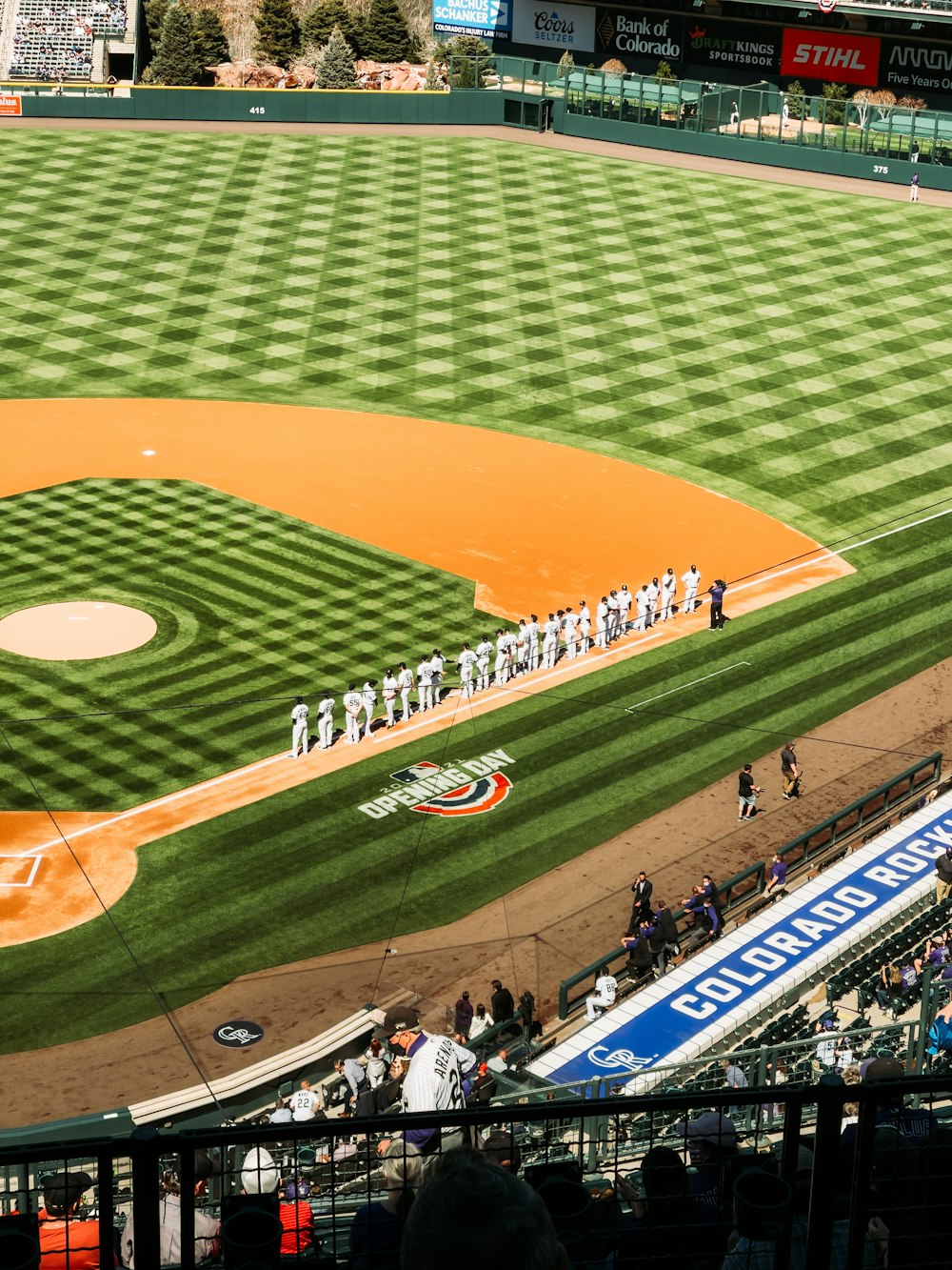 people playing baseball on field during daytime