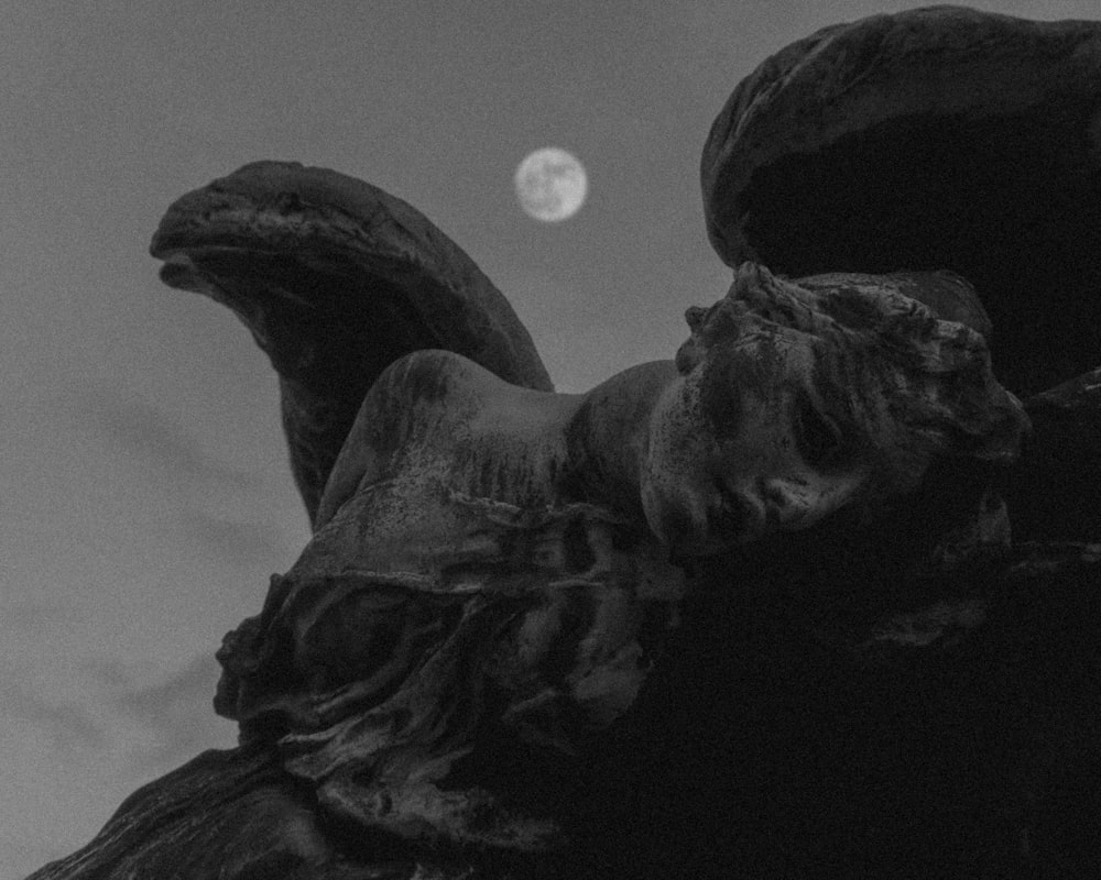 grayscale photo of man statue