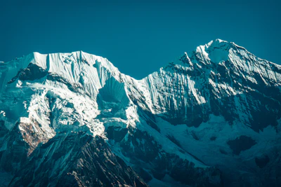 Snow-capped mountain peaks under a clear blue sky