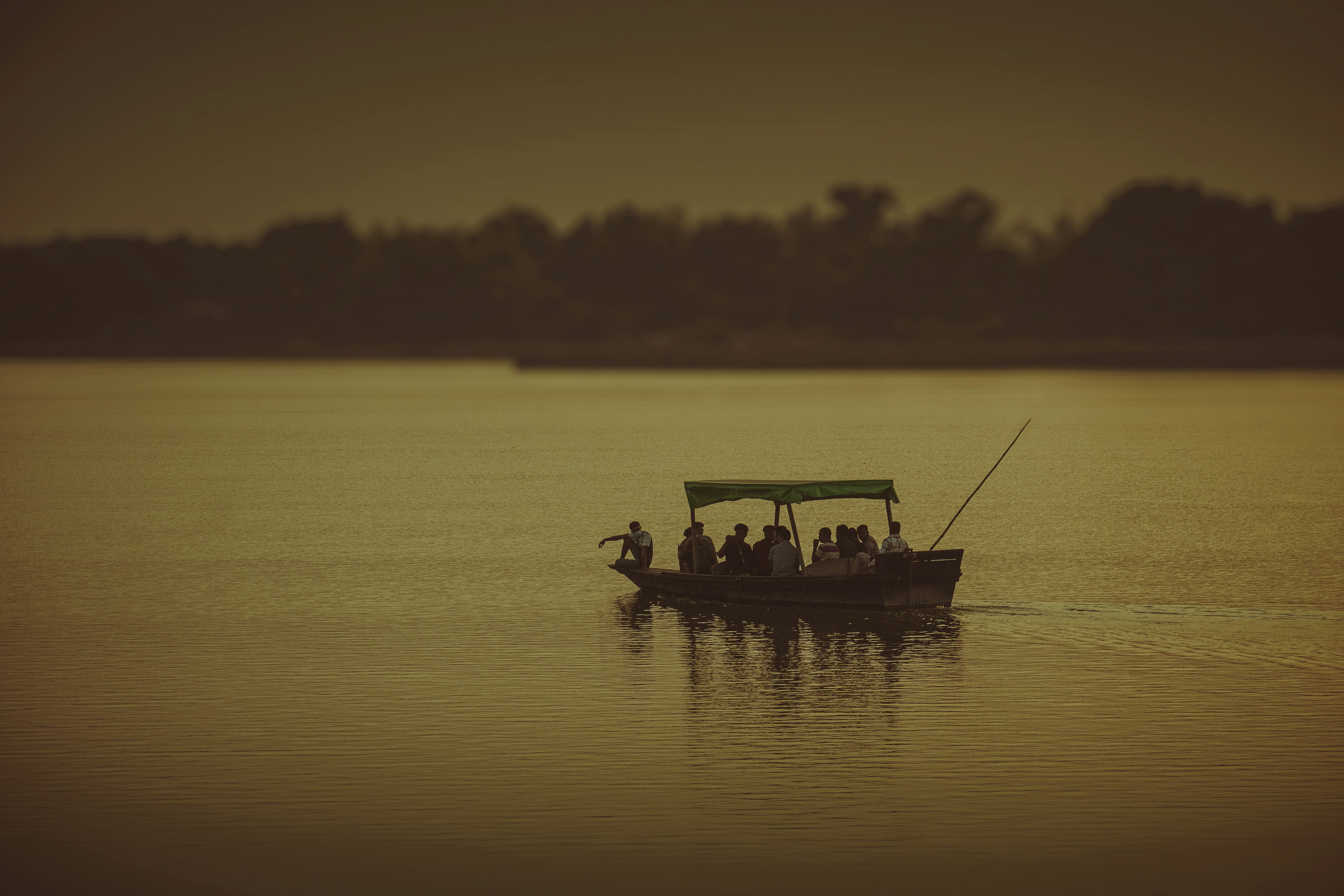Sunset cruise on the Zambezi River with golden reflections and silhouetted trees