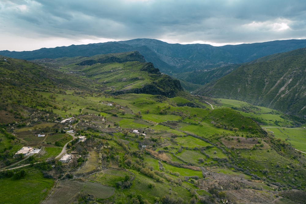 green grass field and mountains during daytime