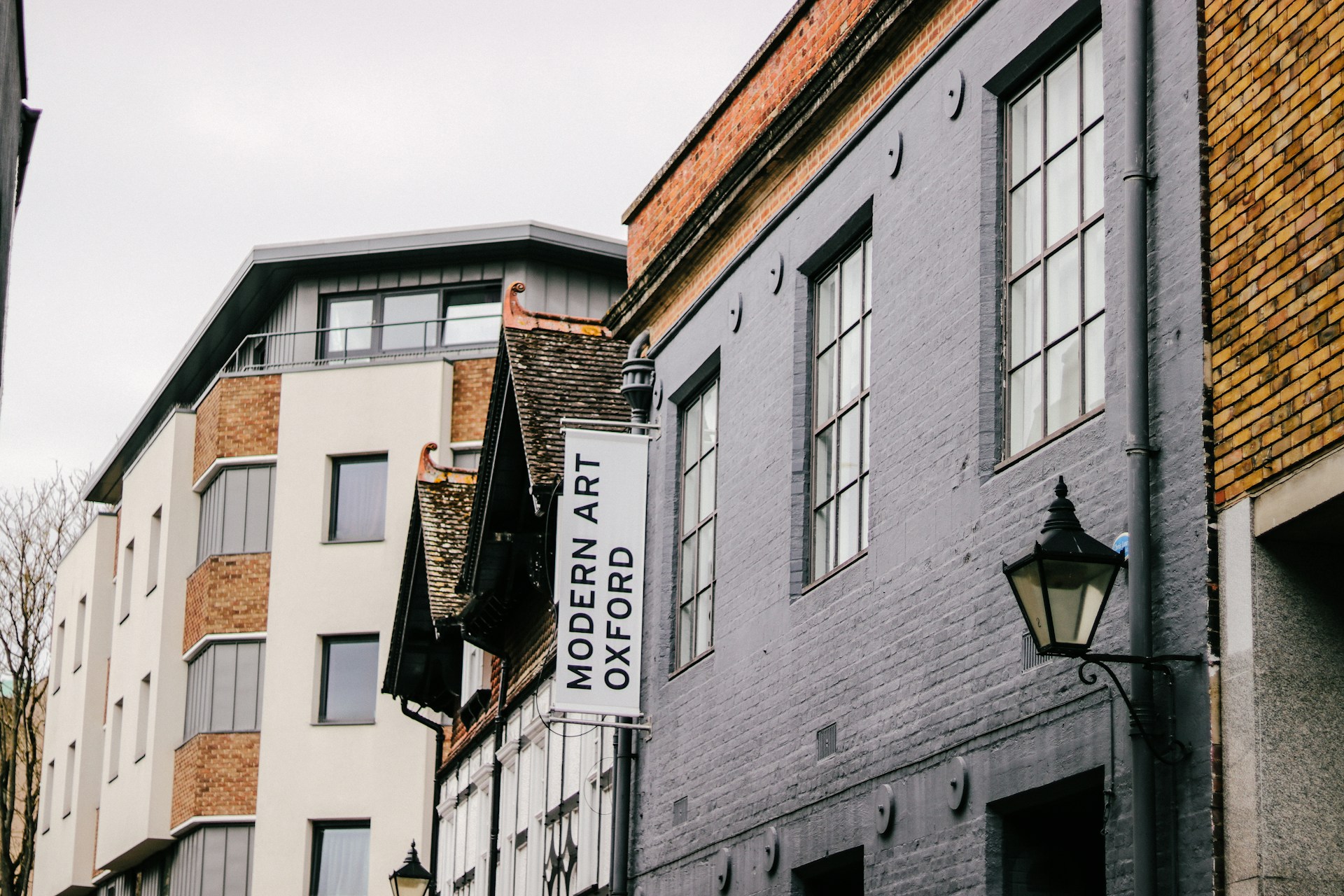 woman wearing yellow long-sleeved dress under white clouds and blue sky during daytime
