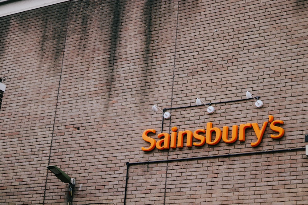 a brick building with a sign that says sainsbury's