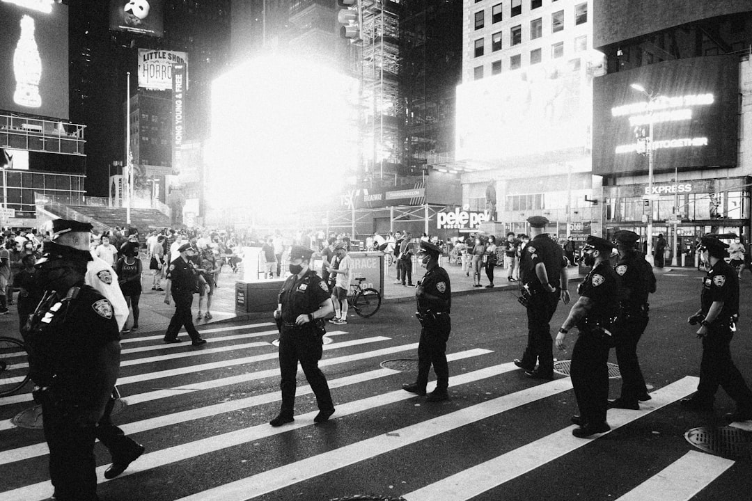 grayscale photo of people walking on pedestrian lane