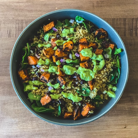 A colorful quinoa salad with black beans, corn, red bell peppers, and cilantro.