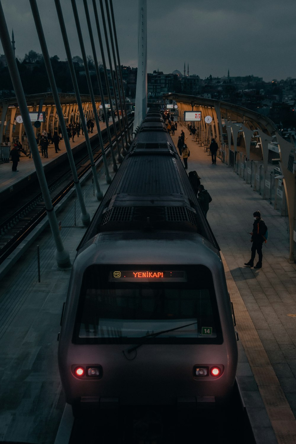 people walking on sidewalk near train during daytime