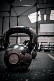 Close-up of a fuelcore kettlebell with a textured grip resting on a gym mat.