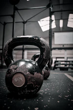 Dynamic shot of a hybrid athlete performing a kettlebell swing in a modern gym.