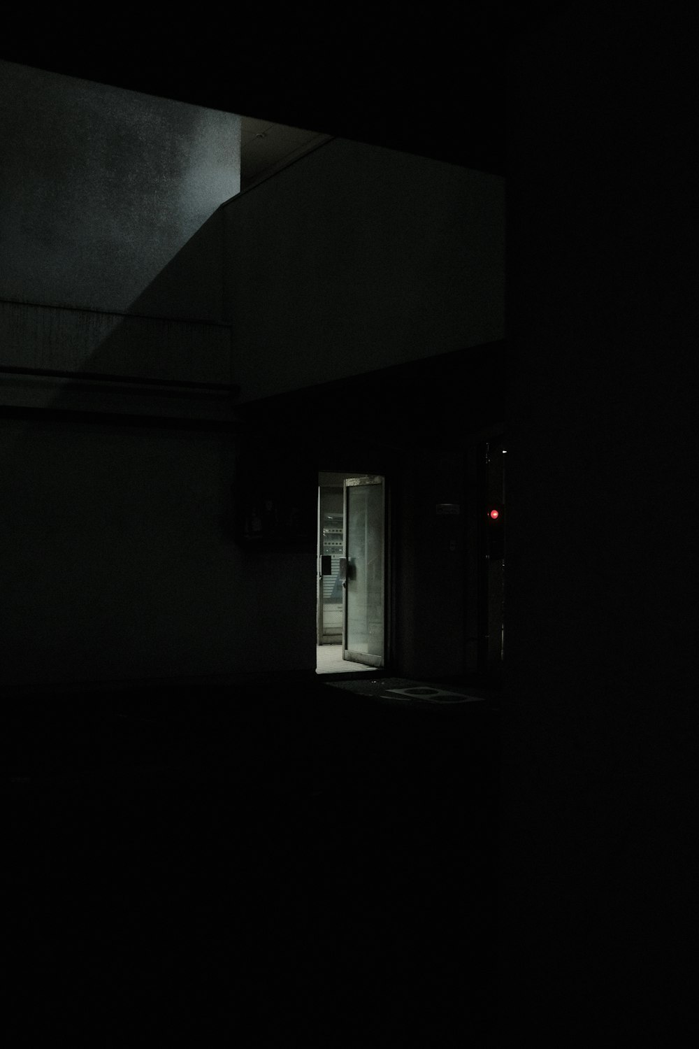 white wooden door in gray concrete building