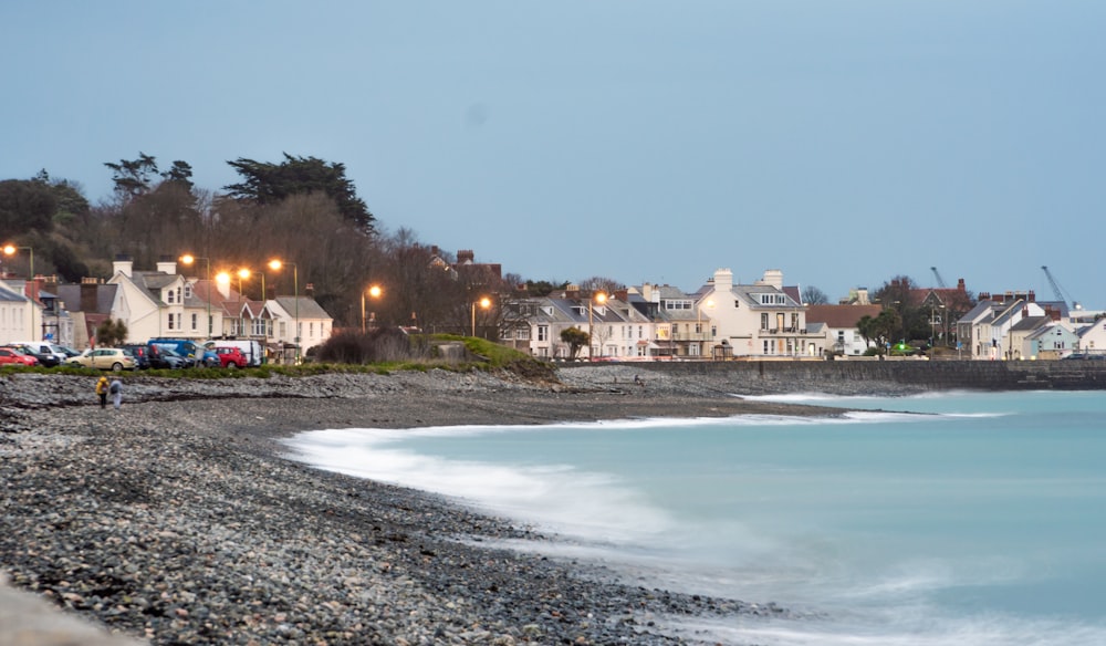 white and brown concrete buildings near sea during daytime