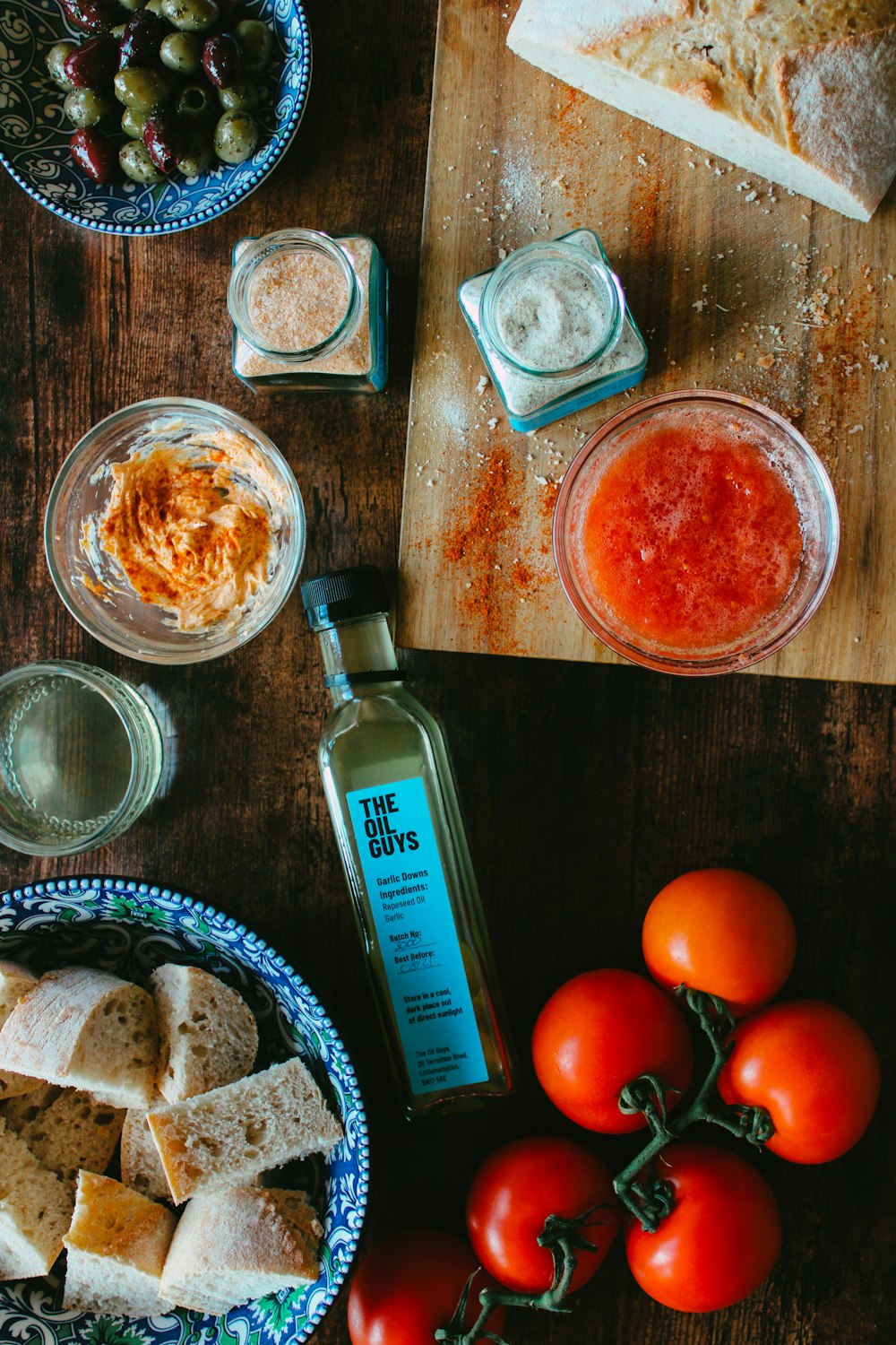 clear glass bottle beside clear glass bowl with orange liquid