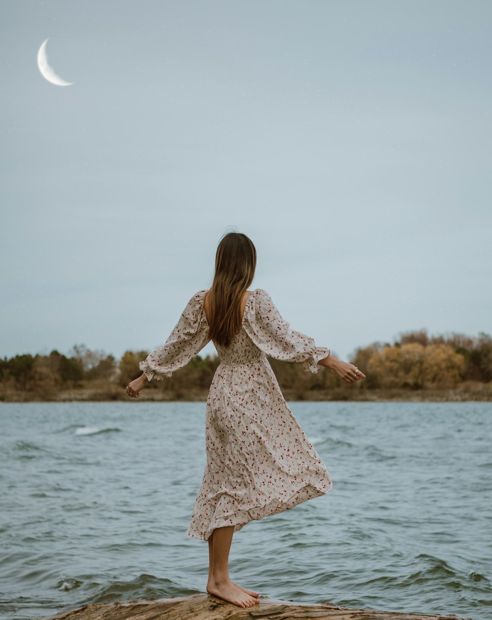 woman in white dress standing on sea shore during daytime