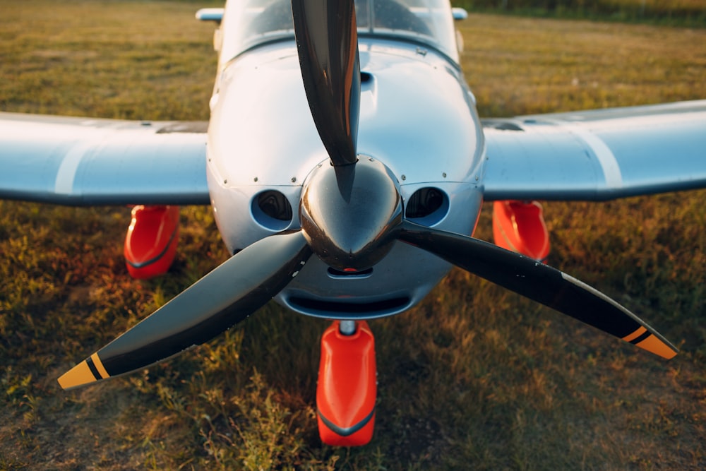 white and red airplane on brown field during daytime