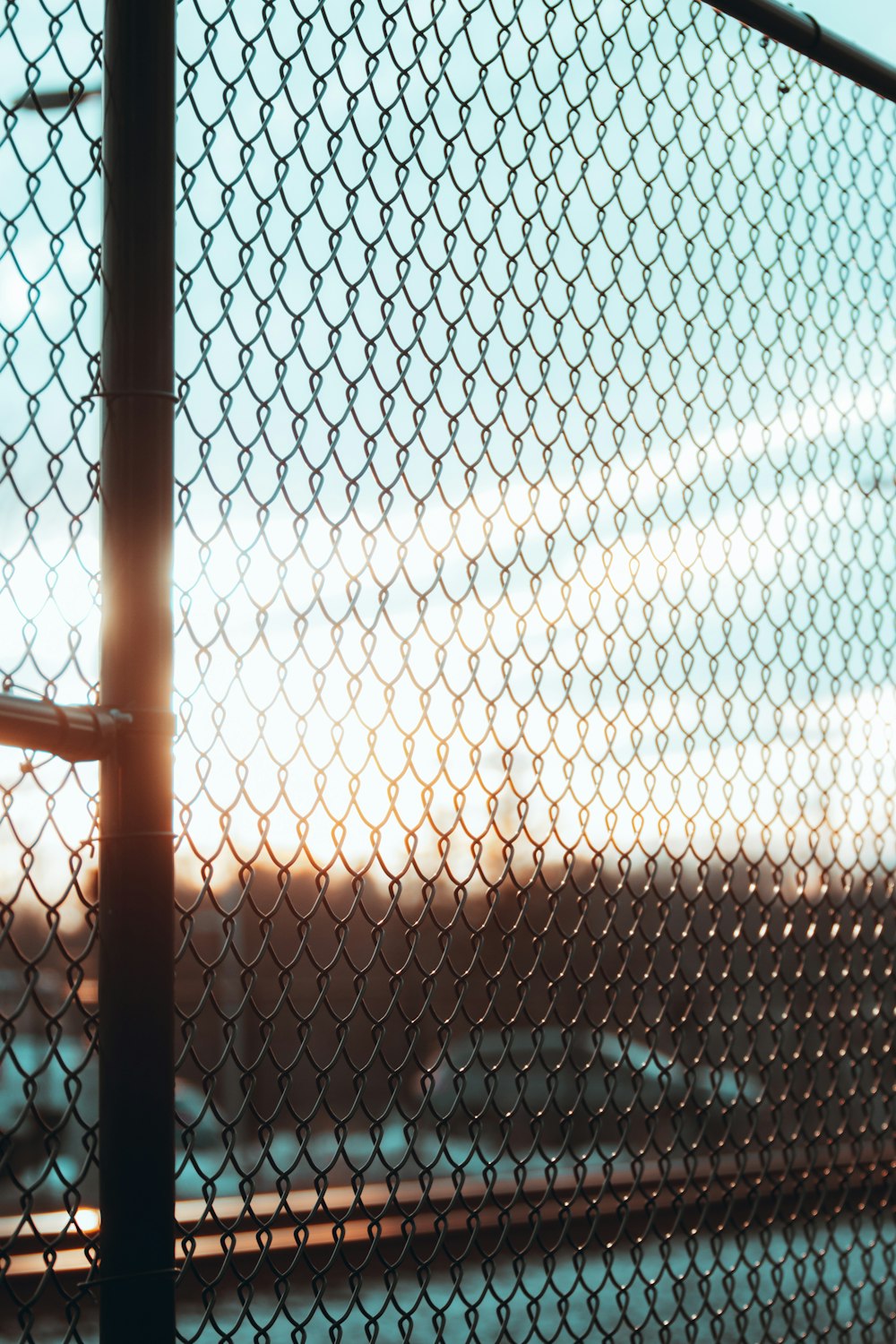 brown metal fence with water droplets