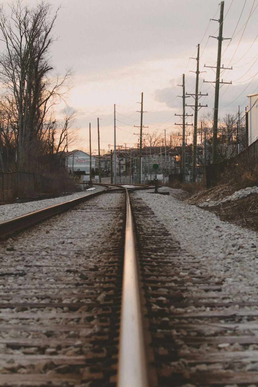 train rail near bare trees during daytime