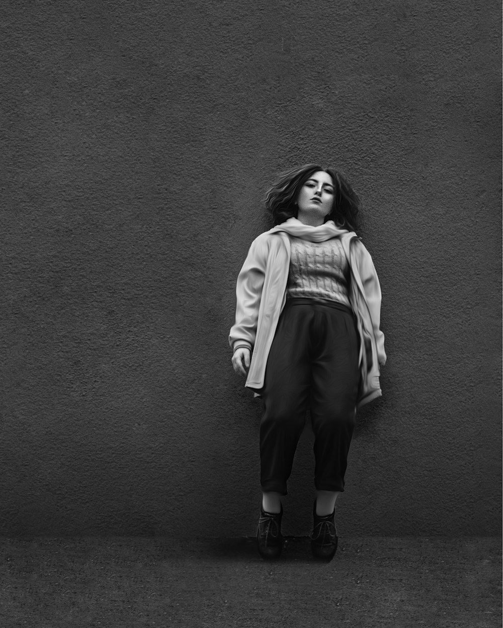 woman in white jacket and black pants standing on gray concrete floor