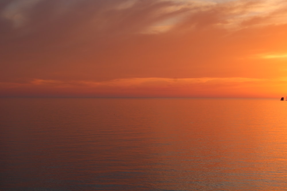 body of water during sunset