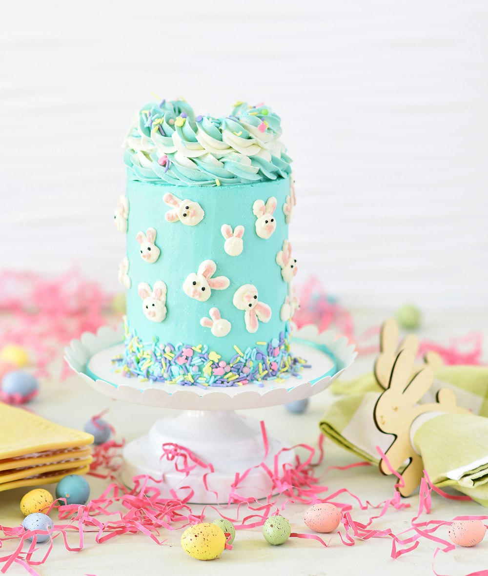 blue and white polka dot cake on pink and white heart shaped cake stand