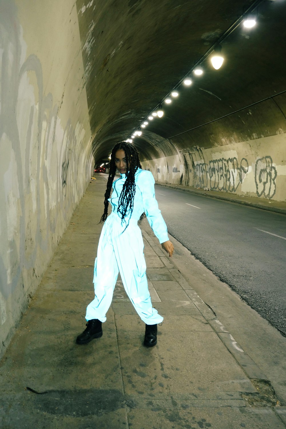 girl in white pajama set standing on gray concrete floor