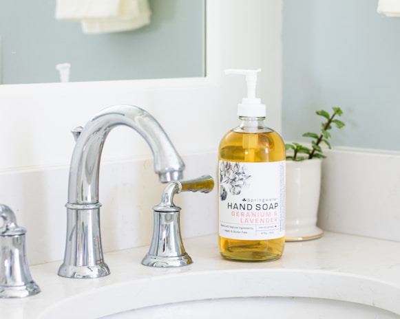 A serene bathroom scene with k&j soaps displayed next to a stylish sink.