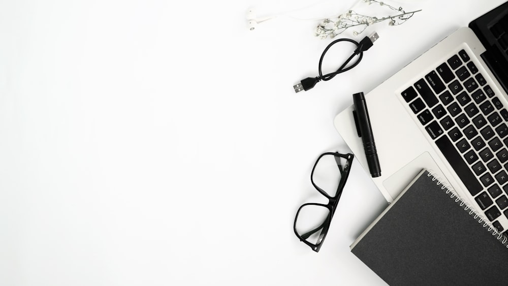 black framed eyeglasses on white table